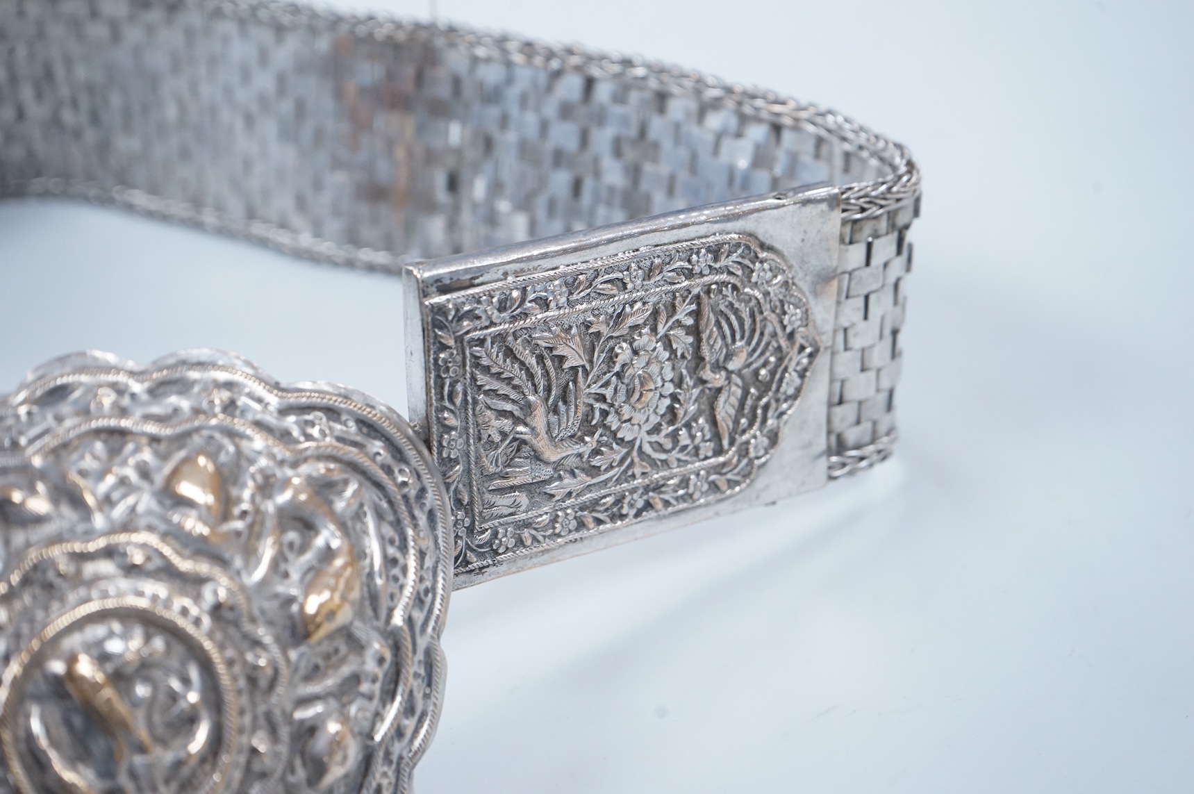 An early 20th century Chinese Straits repoussé white metal belt and buckle, stamped marks, 273g